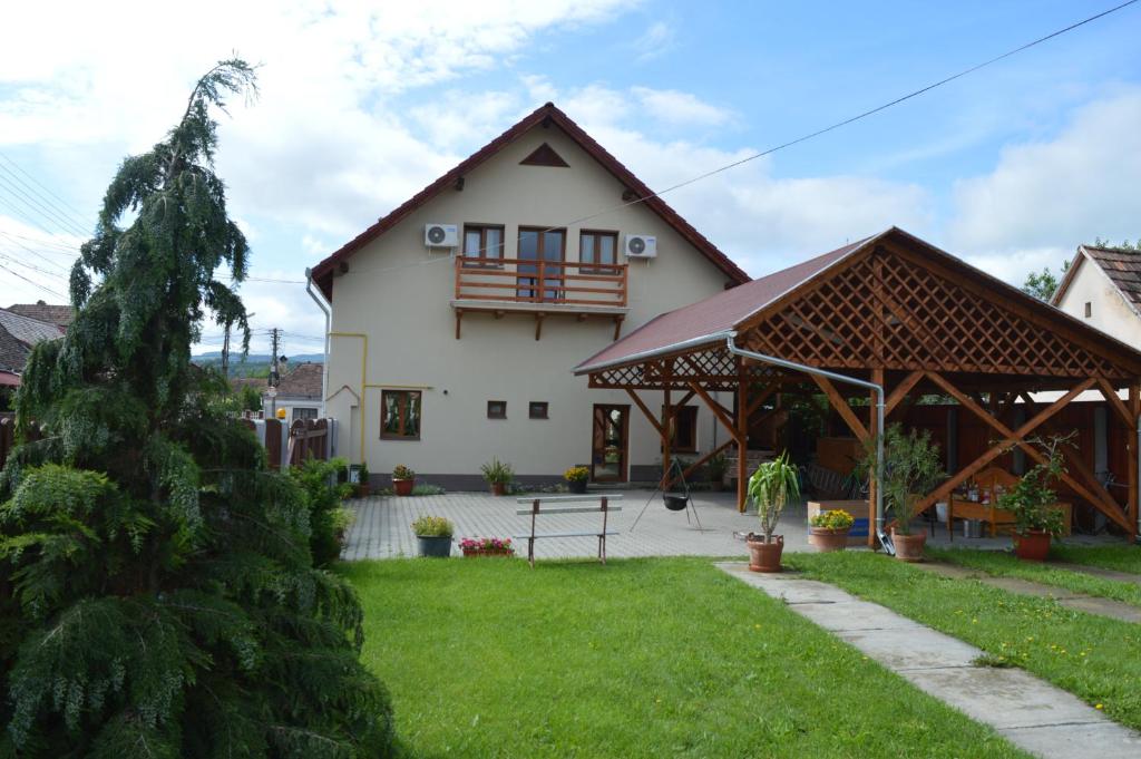 ein Haus mit einem Pavillon im Hof in der Unterkunft Motel Fogado in Cristuru Secuiesc