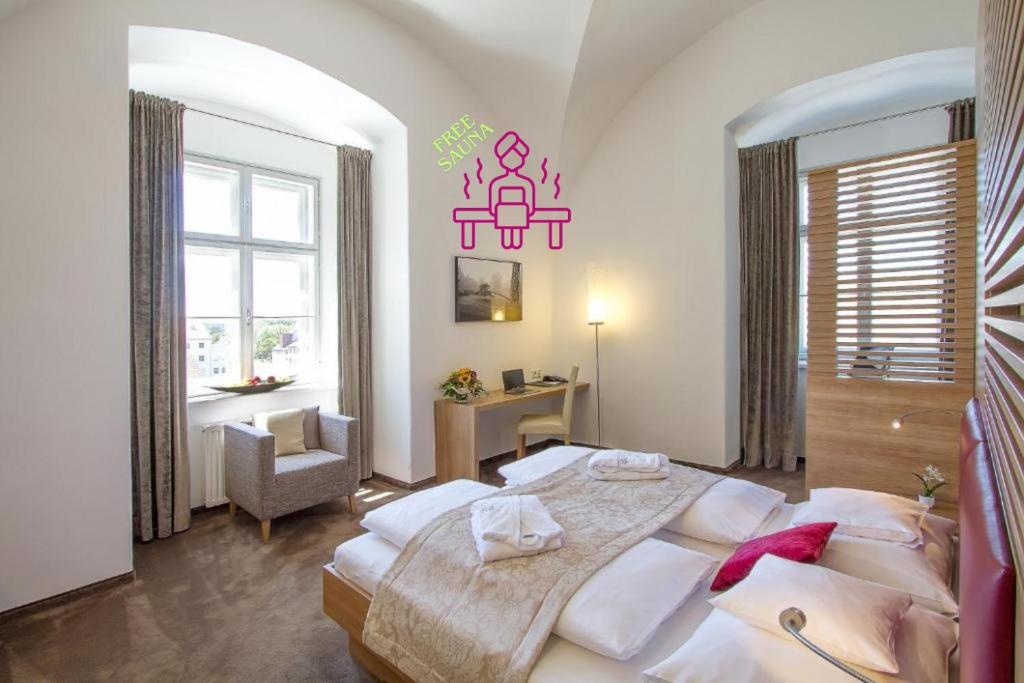 a bedroom with a large bed and a desk at Hotel Altes Kloster in Hainburg an der Donau