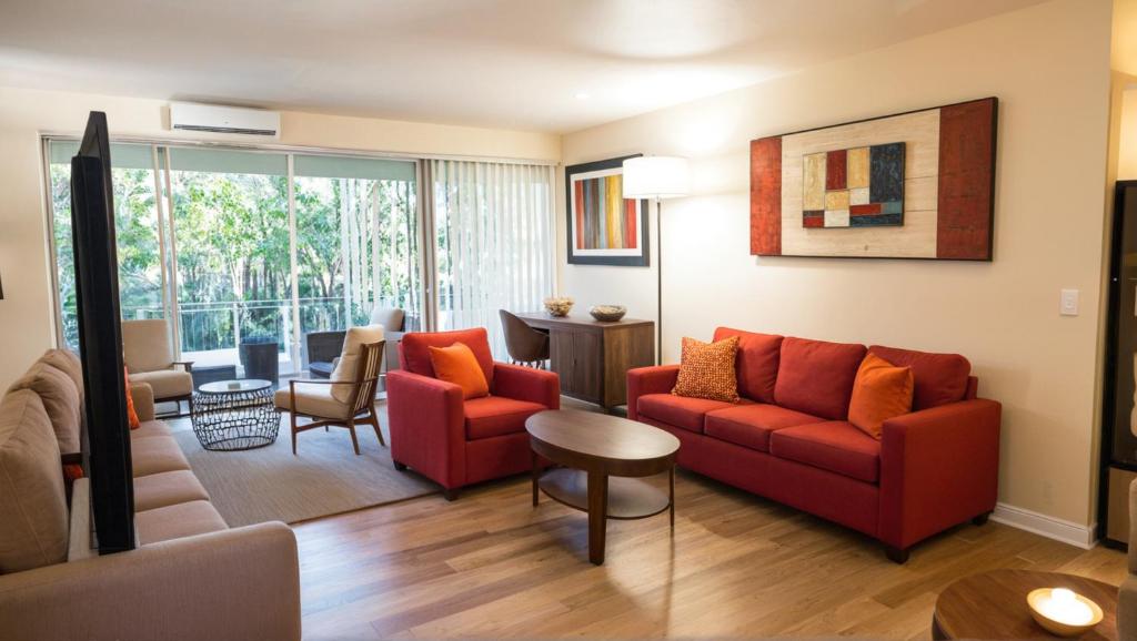 a living room with a red couch and a table at Santa Monica Executive Suites in Los Angeles