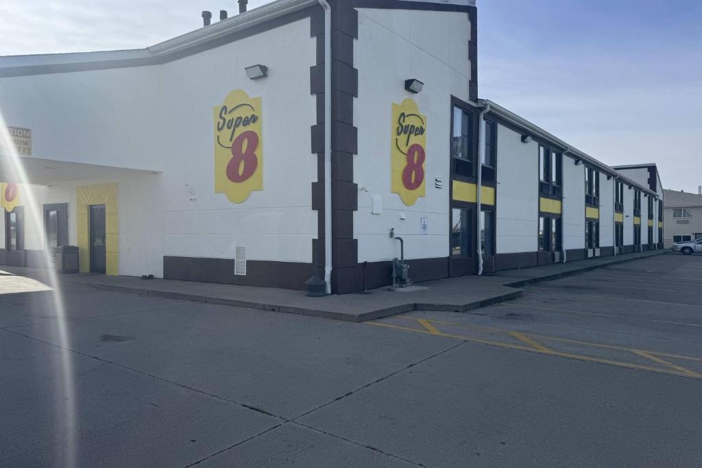 a building with signs on the side of it at Super 8 by Wyndham Lincoln in Lincoln