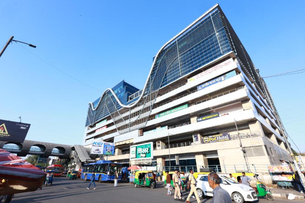 a large building with people walking in front of it at Metro POD Hotel at New Delhi Metro & Railway Station in New Delhi