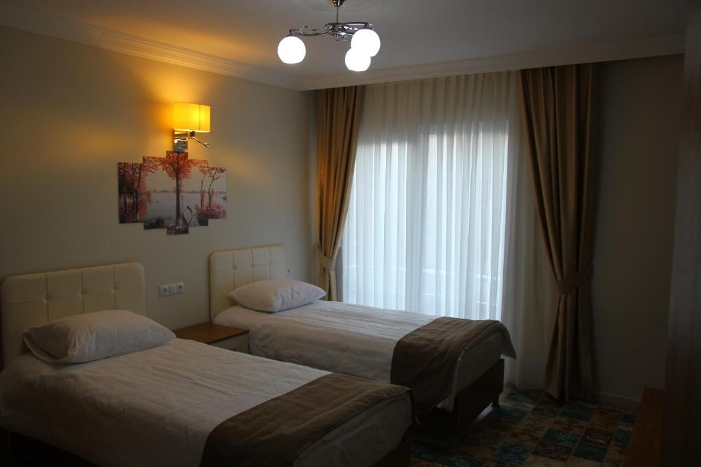 Postel nebo postele na pokoji v ubytování Deveci Hotel