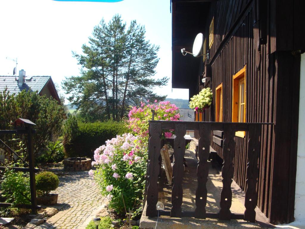 a wooden gate to a house with flowers on it at Apartmán Na Šumavě-Volary in Volary