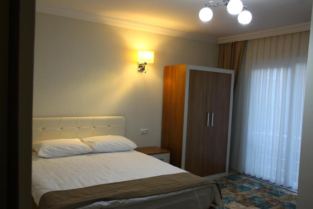 Postel nebo postele na pokoji v ubytování Deveci Hotel