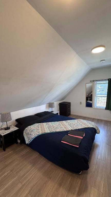 a bedroom with a large bed in a attic at Loft Private Studio -- Washer and Dryer -- Near Boston Transit in Malden
