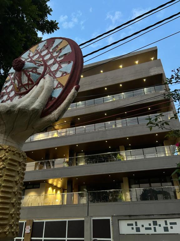 a large building with a clock in front of it at LakeSide Manor in Jāmb