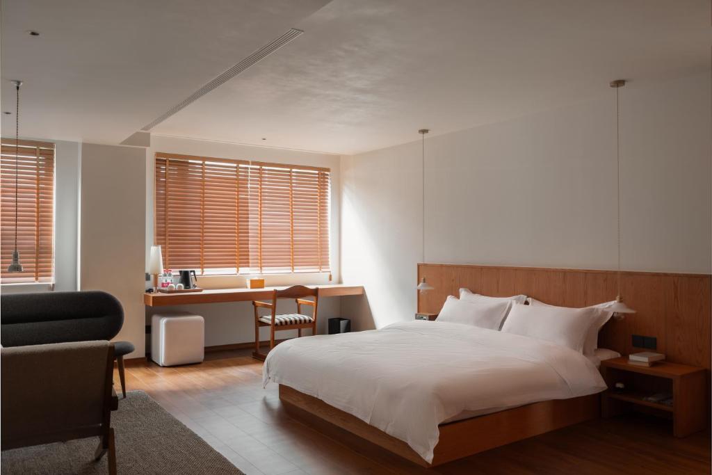 Ένα ή περισσότερα κρεβάτια σε δωμάτιο στο Quanzhou Wuji Homestay