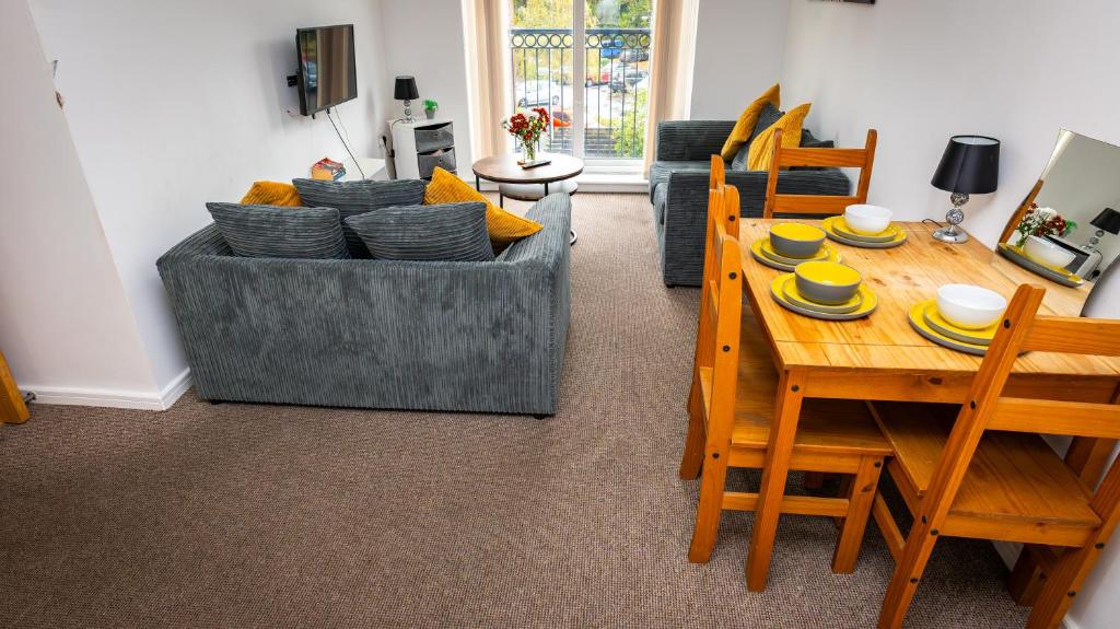 a living room with a table and a couch at Greenings Apt Warrington - 2 Bed with FREE off road Parking & Wifi in Warrington