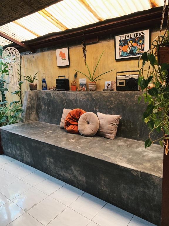 a bench with two pillows on it in a building at Diwas Stay in Yogyakarta