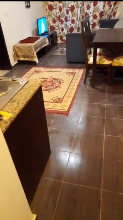 a living room with a table and a rug on the floor at Escape to Heaven in Sharm El Sheikh