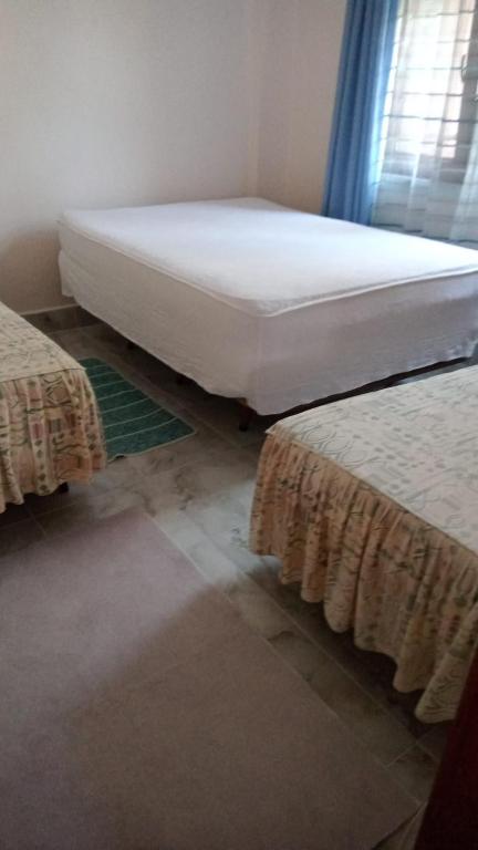 a bedroom with two beds and a window at Angelina's Home and Spa Alexandroupolis in Alexandroupoli