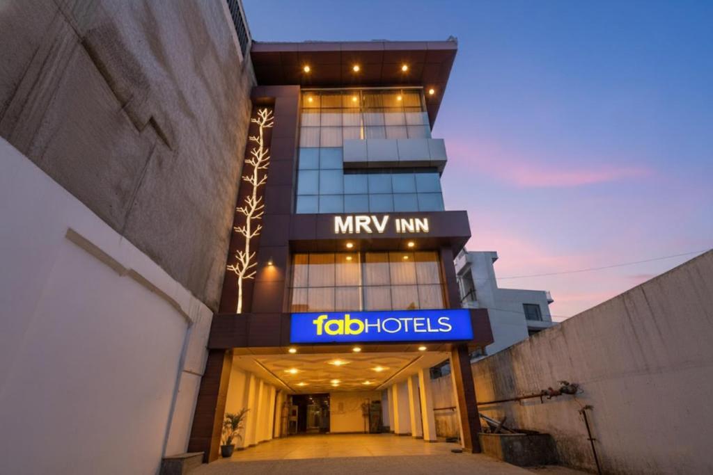 a building with a majid hotels sign in front of it at FabHotel MRV Inn in Chennai