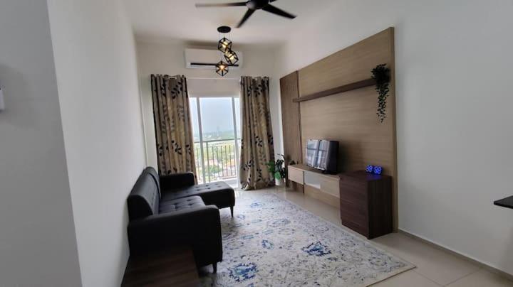 a living room with a couch and a ceiling fan at AL Homestay with 3 Bedrooms in Alor Setar