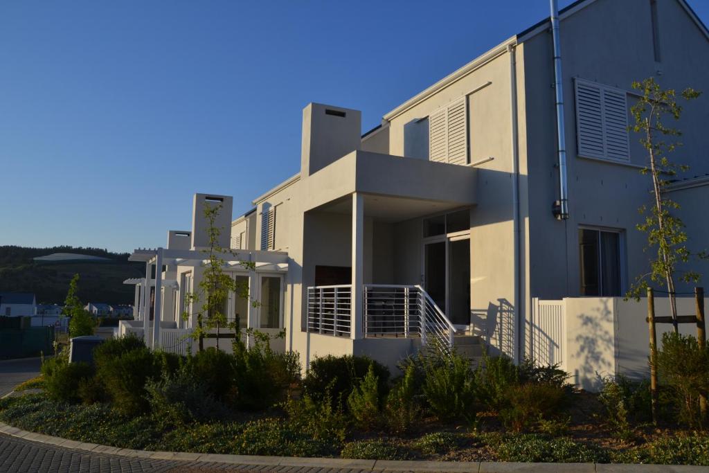 a white building with a blue sky in the background at Casa Voliere in Stellenbosch