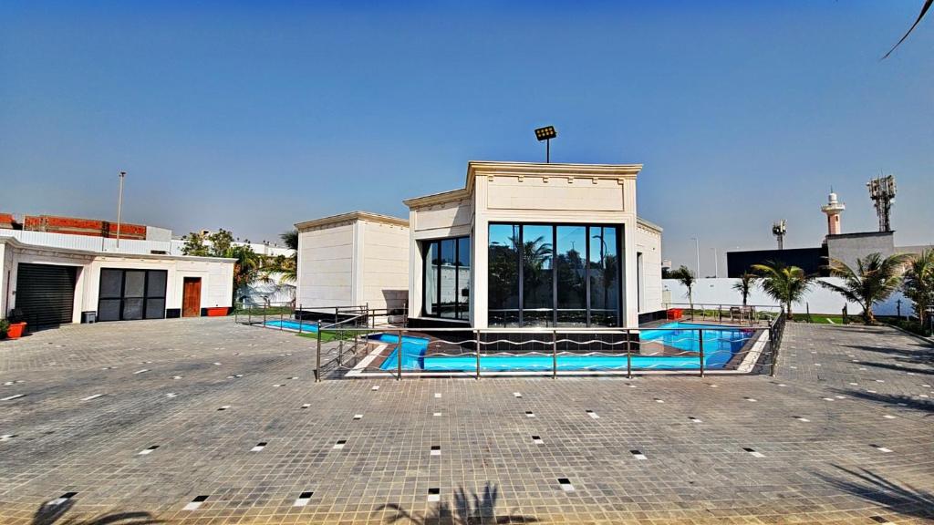 a building with a swimming pool in a parking lot at استراحة الزهراء in Jeddah