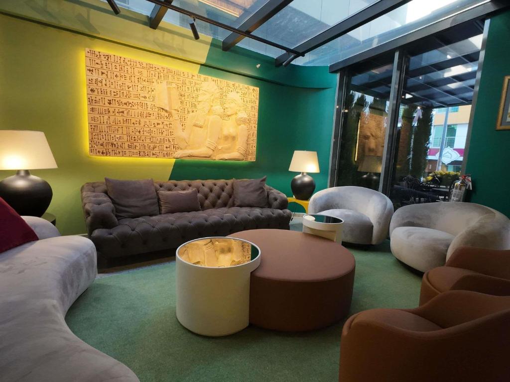 a living room with a couch and a table and chairs at ibis Styles Ankara in Ankara