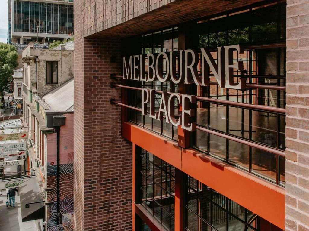 a sign on the side of a building that reads mexophone pace at Hyde Melbourne Place in Melbourne