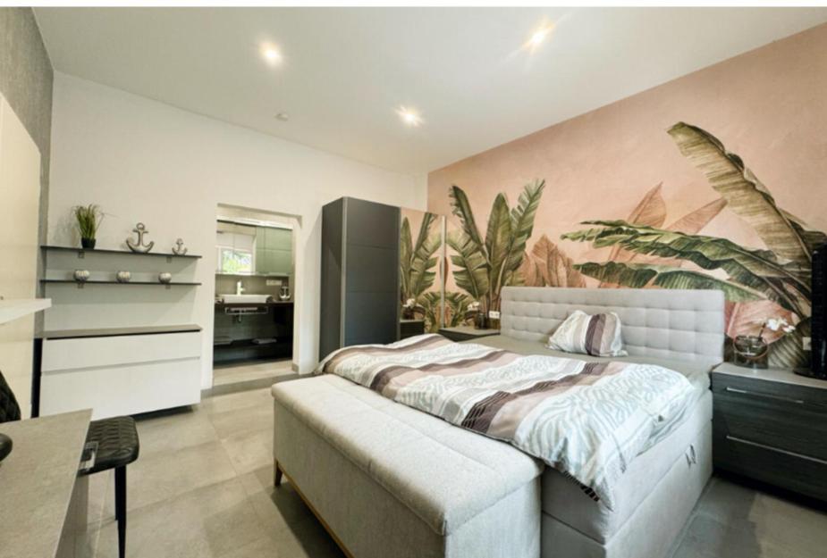 a bedroom with a bed with a large painting on the wall at Speyer Ferienwohnung Apartment 5 in Speyer