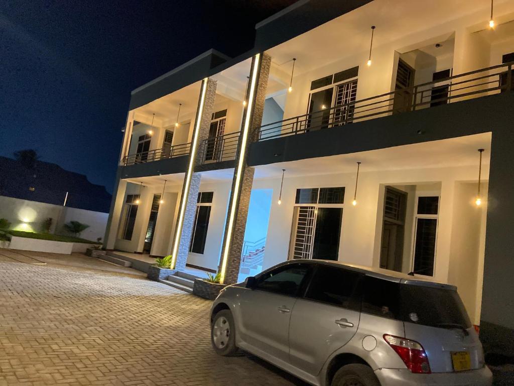 a car parked in front of a building at night at Ynna Stays in Dar es Salaam