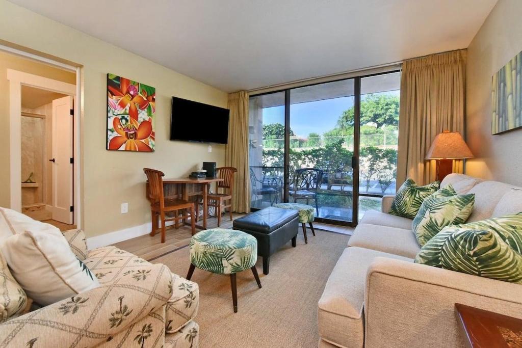 a living room with a couch and a tv and a table at Pacific Shores B102 · PacSB102 Family Getaway 3BD Across Beach in Kihei