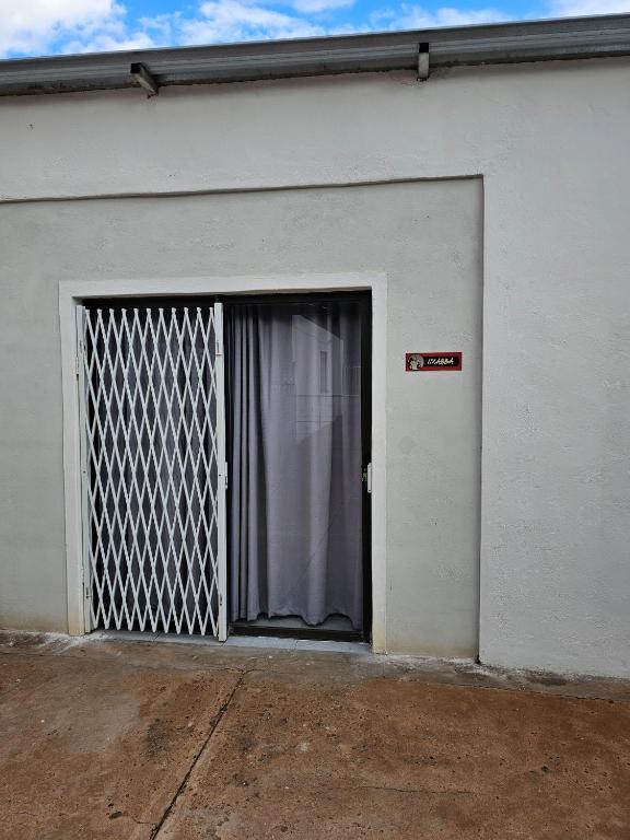 a garage door with a gate in the side of a building at Lalapanzi - Nxabba in Olifantshoek