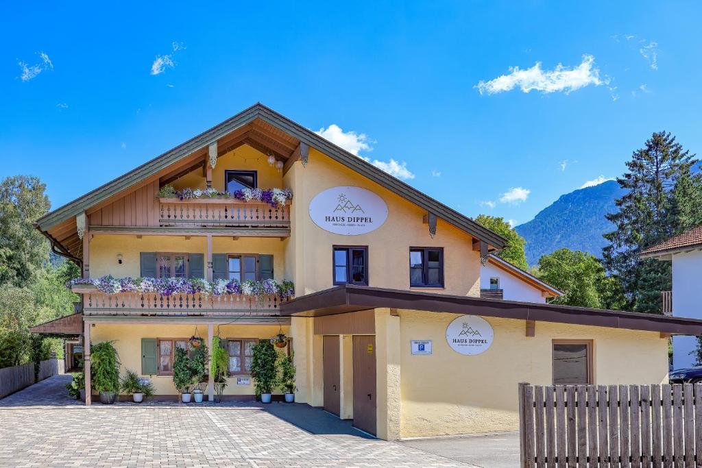 a house with a balcony on top of it at Haus Dippel am Kurpark inklusive Chiemgaukarte in Ruhpolding