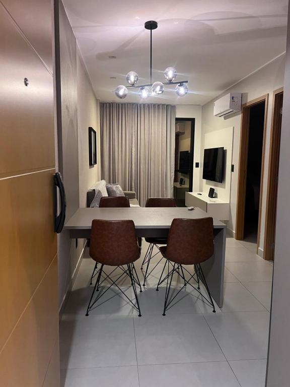 a dining room table and chairs in a room at Studio Design 3 Lions in Maceió