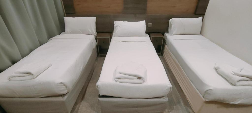 Ένα ή περισσότερα κρεβάτια σε δωμάτιο στο فندق دار المتكاملة 3