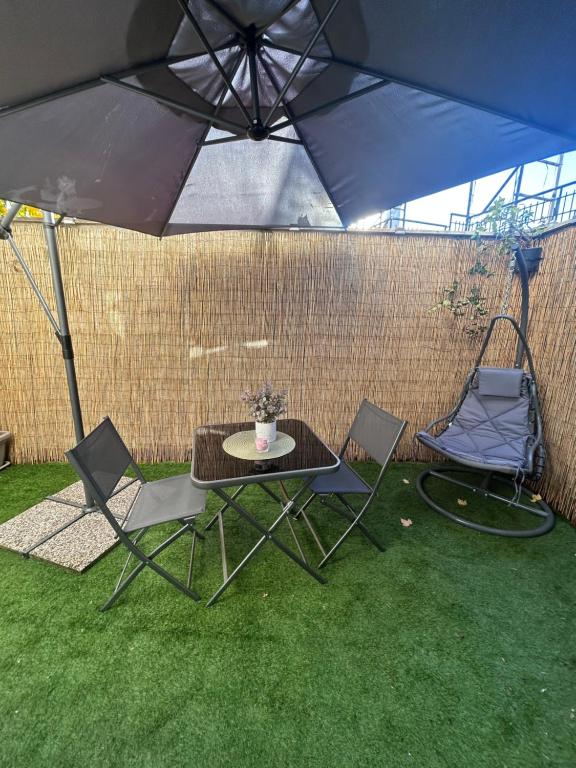 a table and two chairs under an umbrella at WonderHouse casa vacanze in Boiano