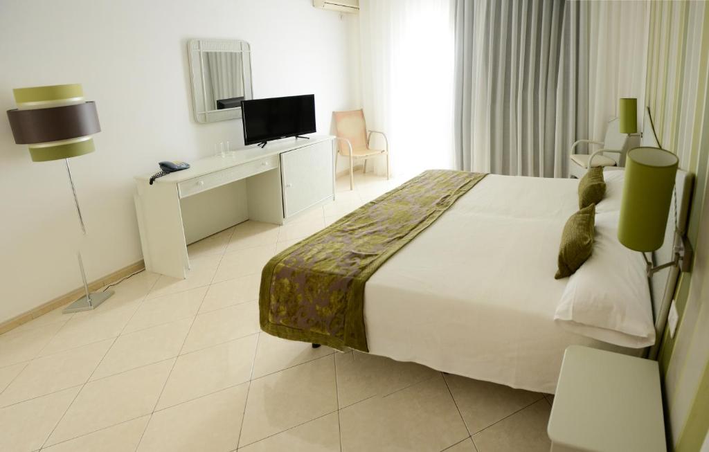 Postel nebo postele na pokoji v ubytování Ouril Pontao Hotel