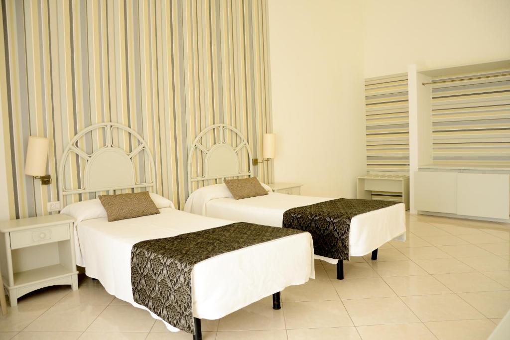 Postel nebo postele na pokoji v ubytování Ouril Pontao Hotel
