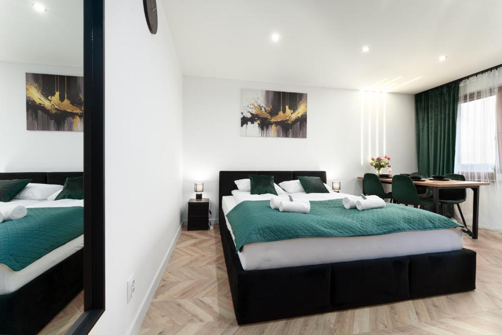 a bedroom with two beds and a table and a desk at Modern Home in Sosnowiec