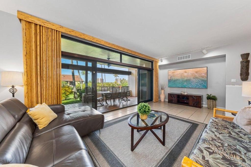 a living room with a couch and a table at Kaanapali Royal H101 · KRL H101 Remodel 2BD Condo Pool Kaanapali in Kaanapali