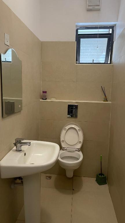 a bathroom with a sink and a toilet and a window at Lakowe Lakes Golf Estate in Ajibade