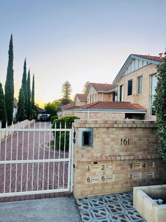 a gate to a house with the number on it at Affordable accommodation in Perth