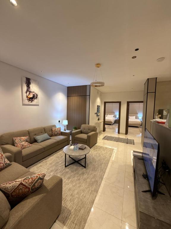a living room with two couches and a table at شقة البدر in Medina