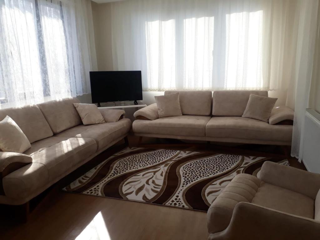 a living room with a couch and a flat screen tv at ziraat in Soma