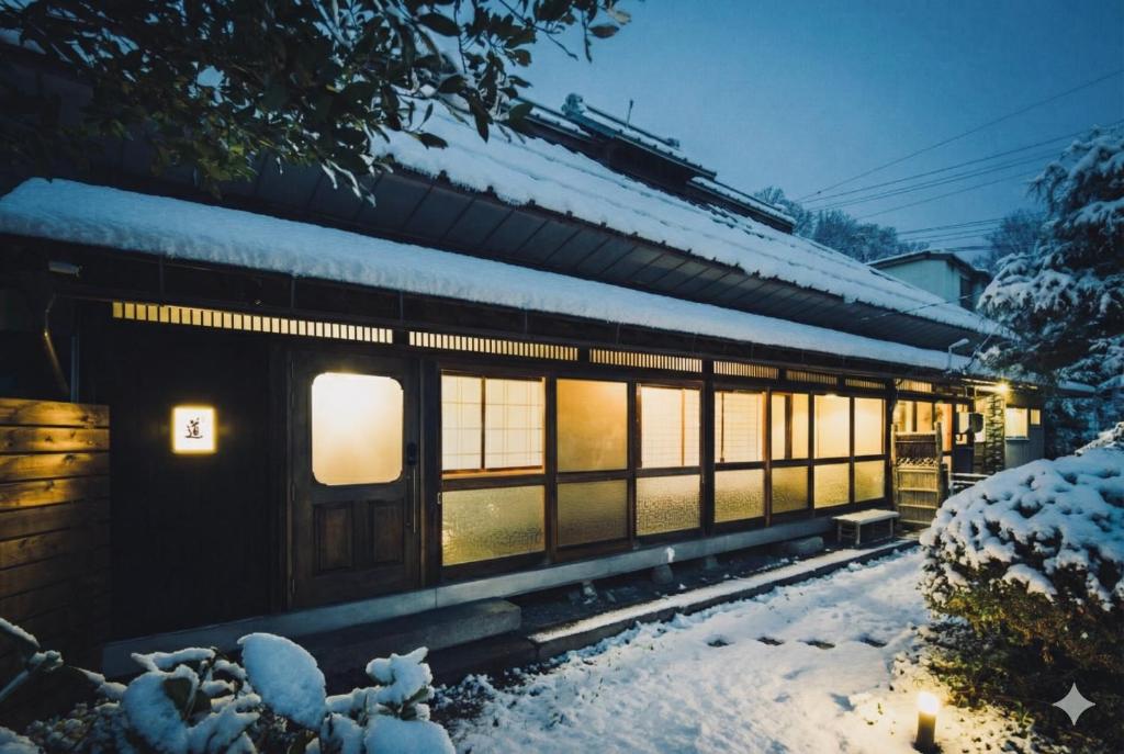ein Bahnhof mit Schnee auf dem Boden in der Unterkunft Gateway to Hakuba & Snow Monkey - Historic 200yo Home in Nagano