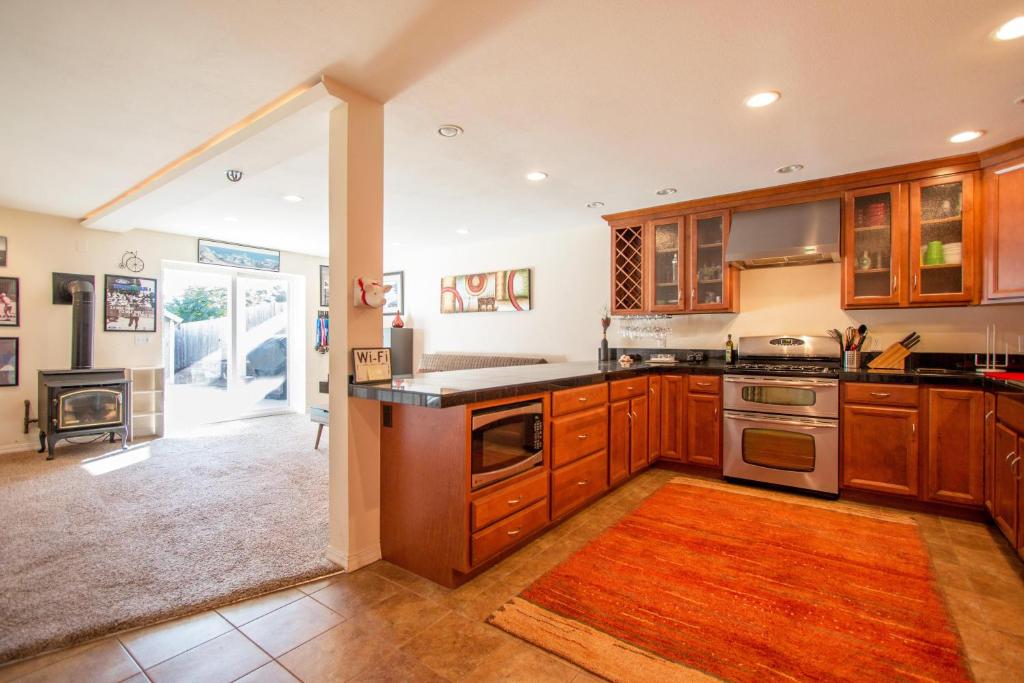 a kitchen with wooden cabinets and a stove top oven at Northern Daylights in White Salmon