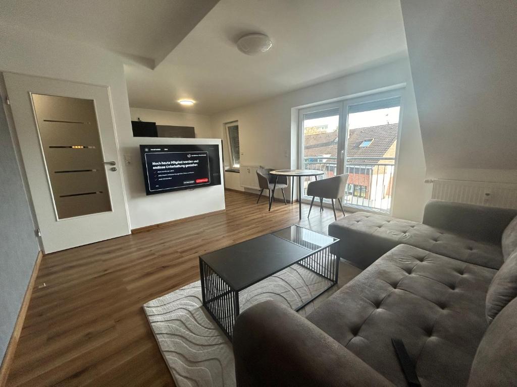 a living room with a couch and a table at Apartment Lori in Mönchengladbach