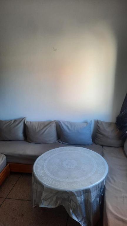 a white coffee table in front of a couch at sweet area in Mirleft