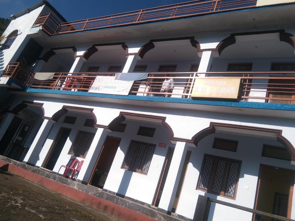 a white building with a balcony at Hotel B M AND SONS in Phata