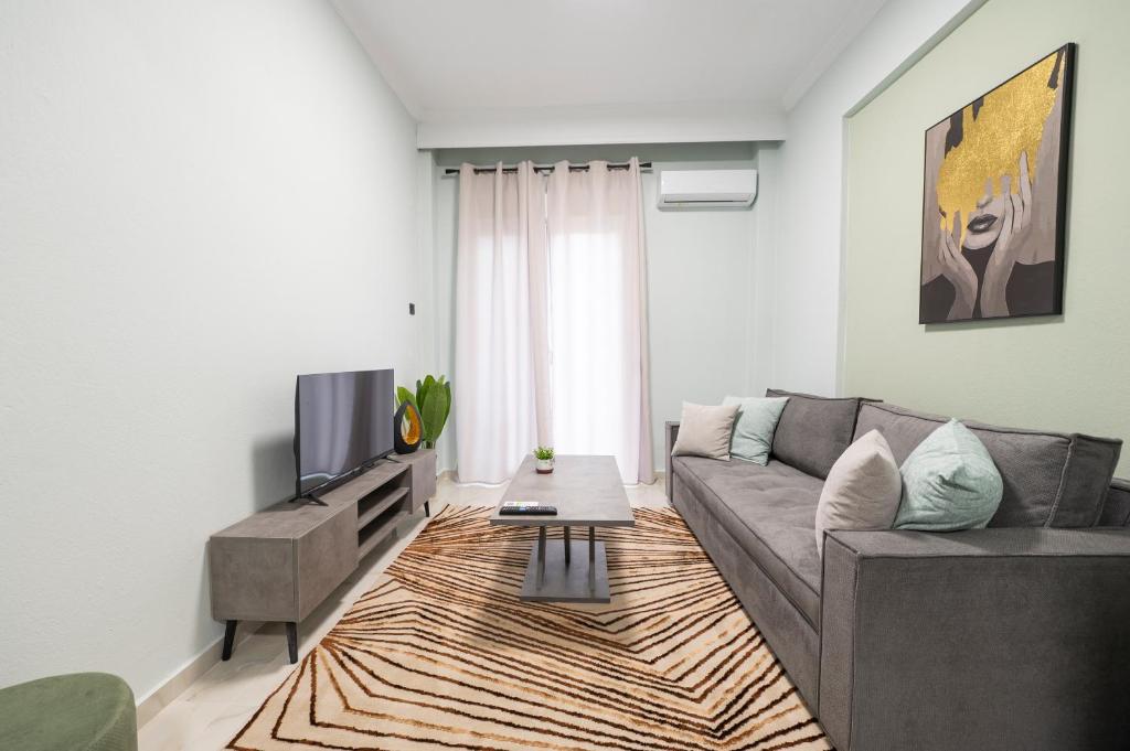 a living room with a couch and a tv at Serra Modern Apt " Free Parking " Quiet " Near Center in Serres