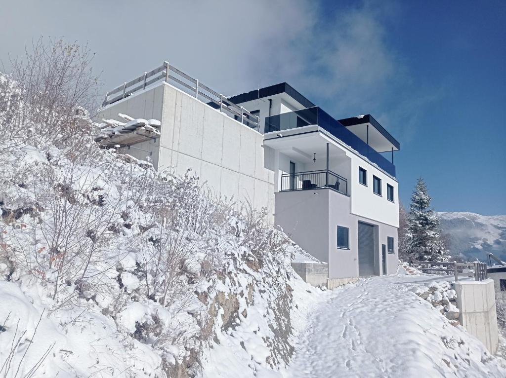 a building on top of a snow covered hill at Panorama Wildgrat in Wenns