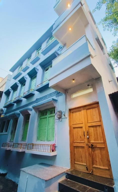 a building with a wooden door in front of it at Johari Heritage Home in Ujjain