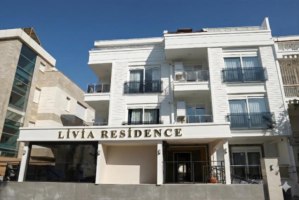 un bâtiment blanc avec une pancarte indiquant résidence des hyènes dans l'établissement Livia Residence, à Antalya