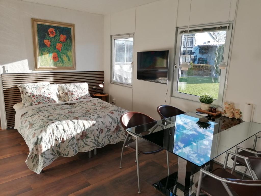 une chambre avec un lit et une table en verre dans l'établissement Family apartment in Kværs - bunk bed, kitchen and EV Charging, à Gråsten