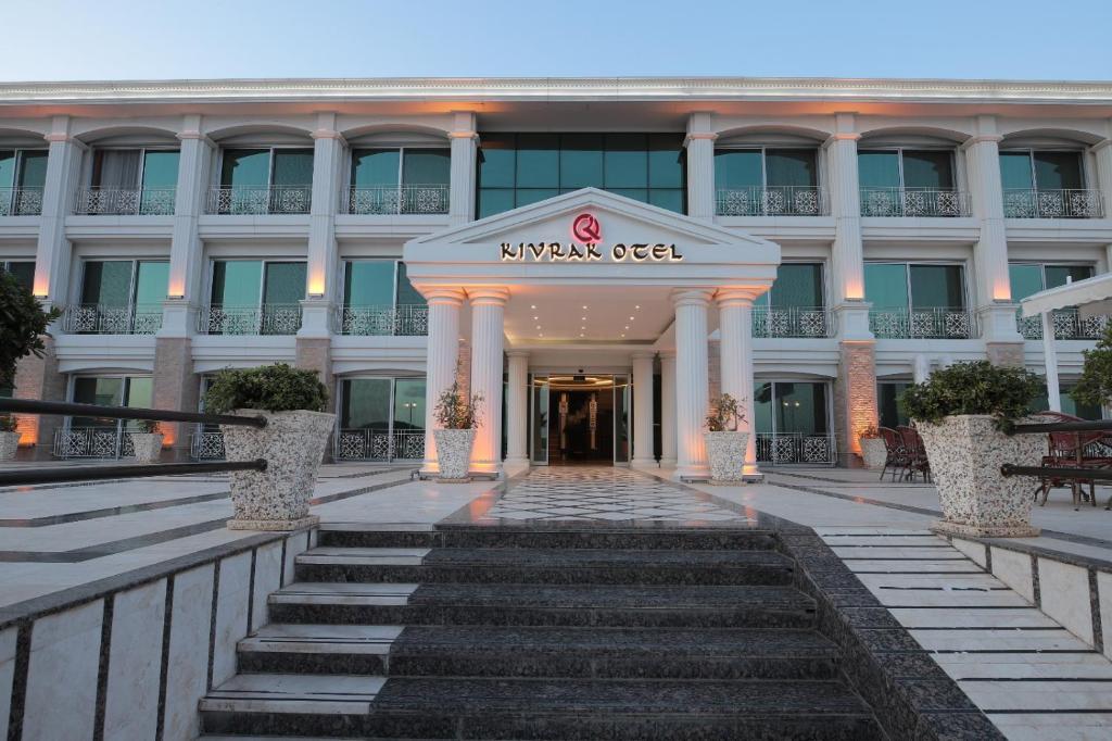 a hotel entrance with stairs in front of a building at Cunda Kivrak Hotel in Ayvalık