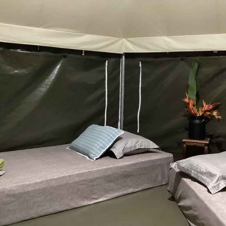 a bed in a tent with two pillows on it at Anatolia Retreat in Bentong