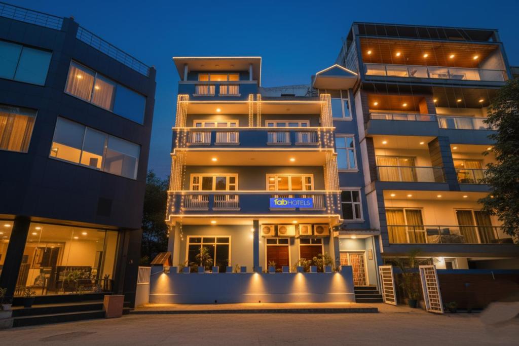 a large apartment building at night at FabHotel JHS Studio in Gurgaon